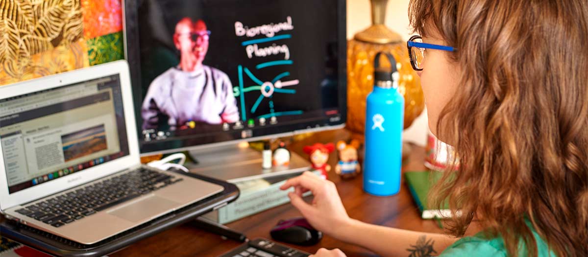 Student at home computer, conferencing with professor Jaap Vos.