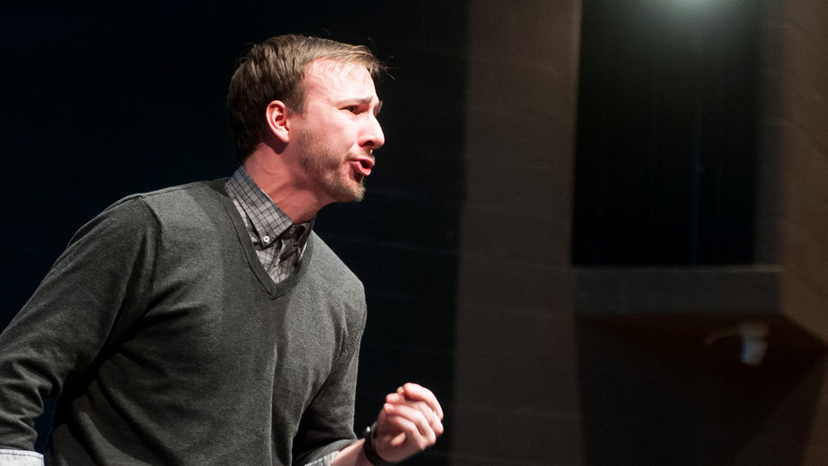 An actor performs on stage in the Hartung Theatre.