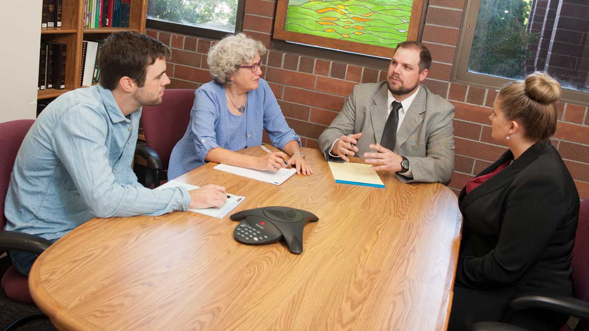 Law students meeting with clinic faculty.