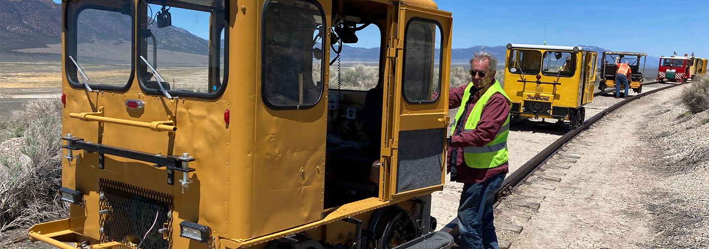 Thomas Griggs stands next to his restored railroad maintenance car.