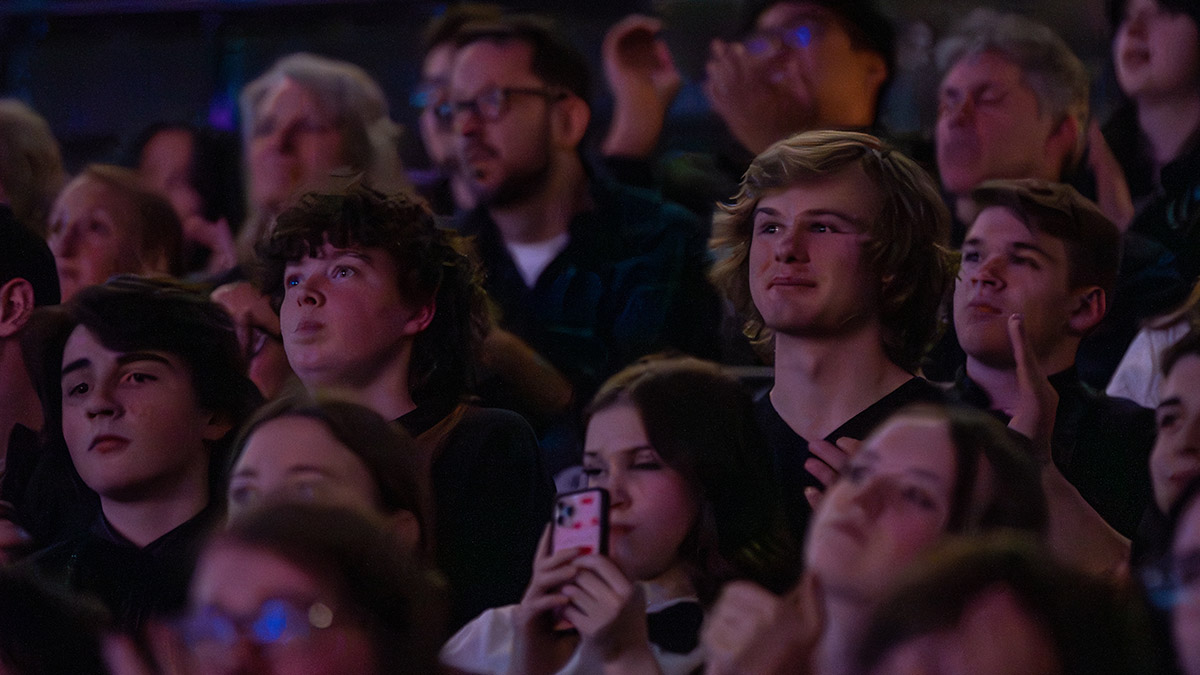 An audience watching a performance at a theatre