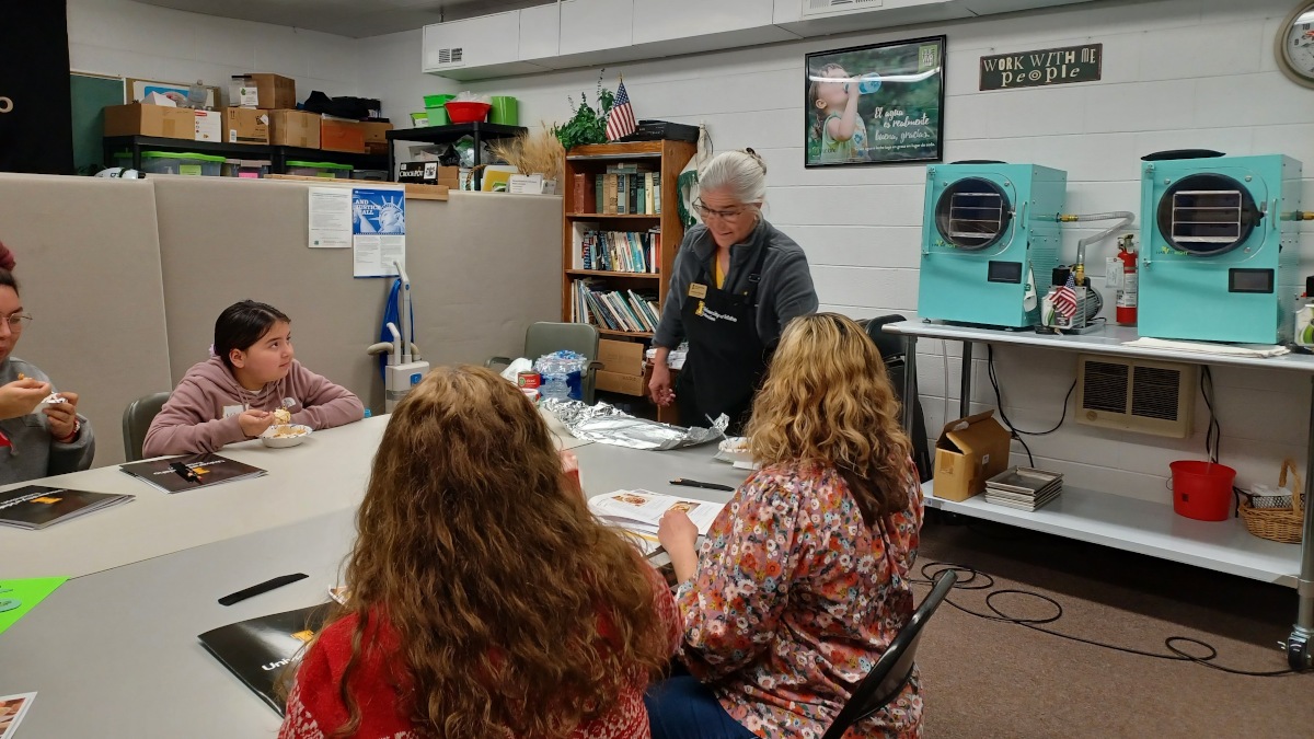 Students of various ages listen to instructor Gretchen Manker.