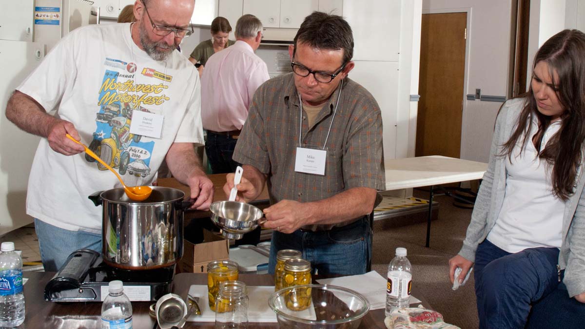 A group learning how to can and preserve food