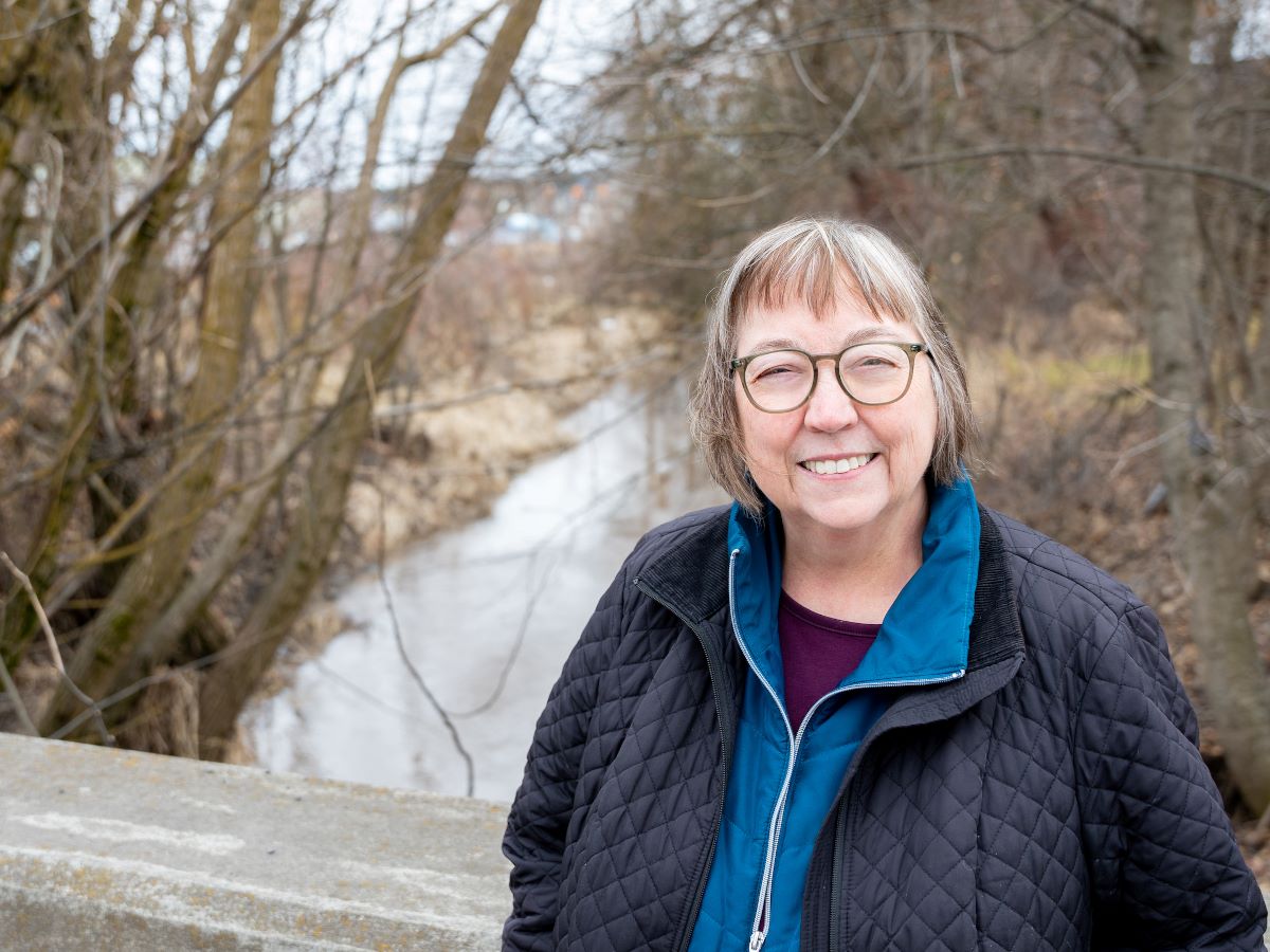 Karen Hume posing in front of a river