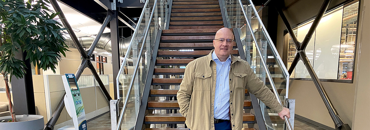 Skinner standing in front of  a staircase