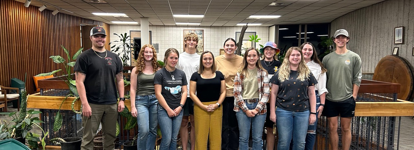 A line of students stands in a building.