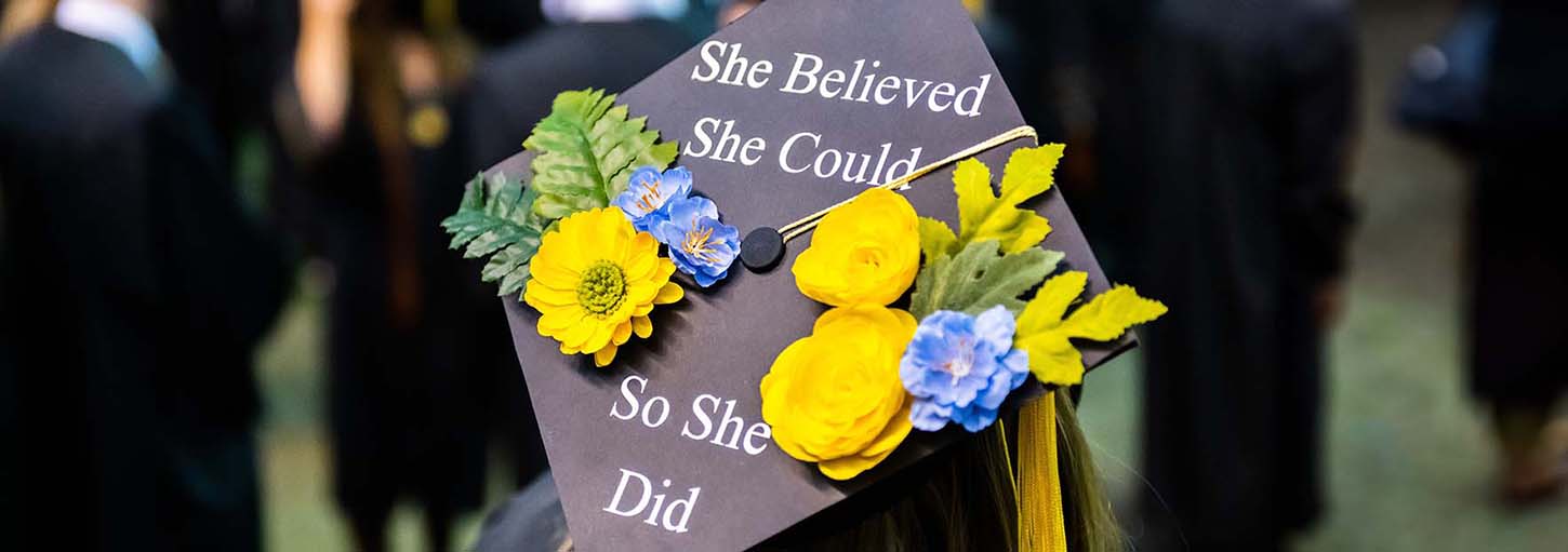 Photo of back of graduation cap at ceremony.