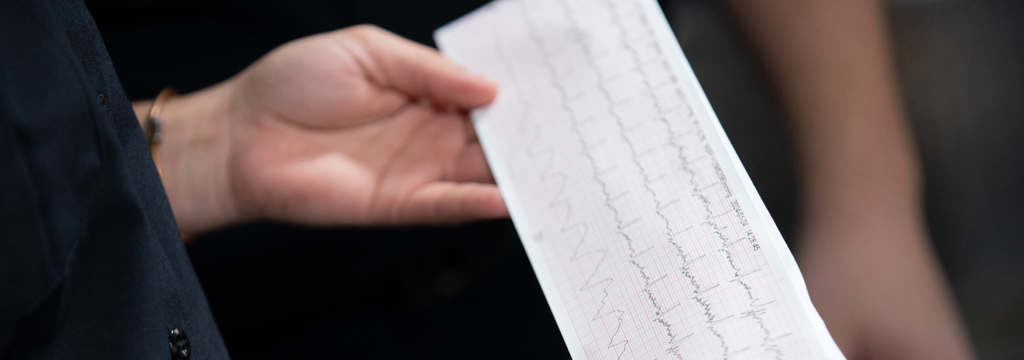 Hand holds a sheet of health data.