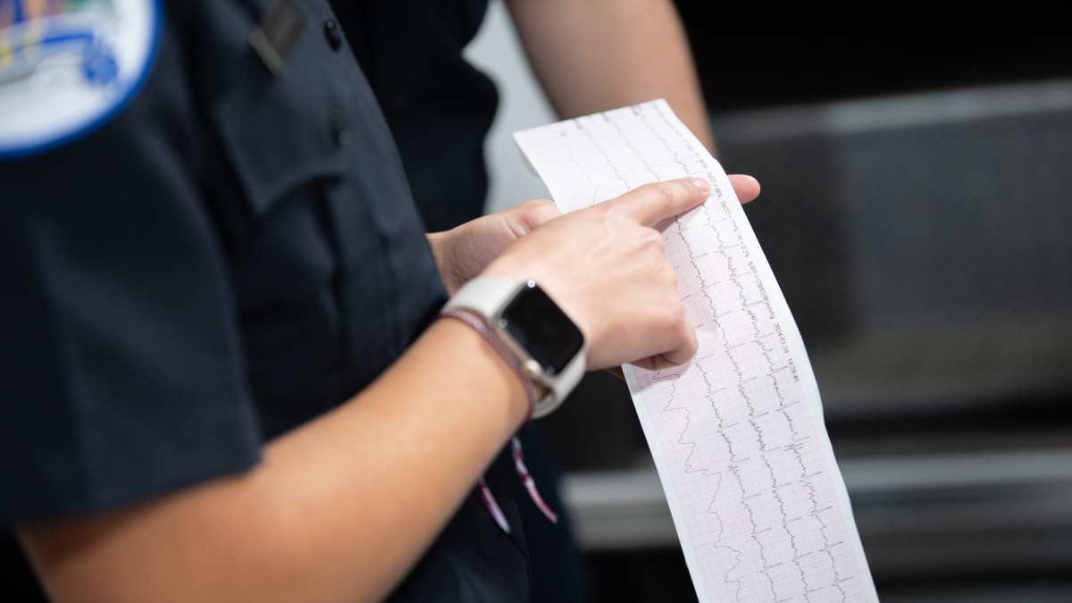 Hand holds a sheet of health data.