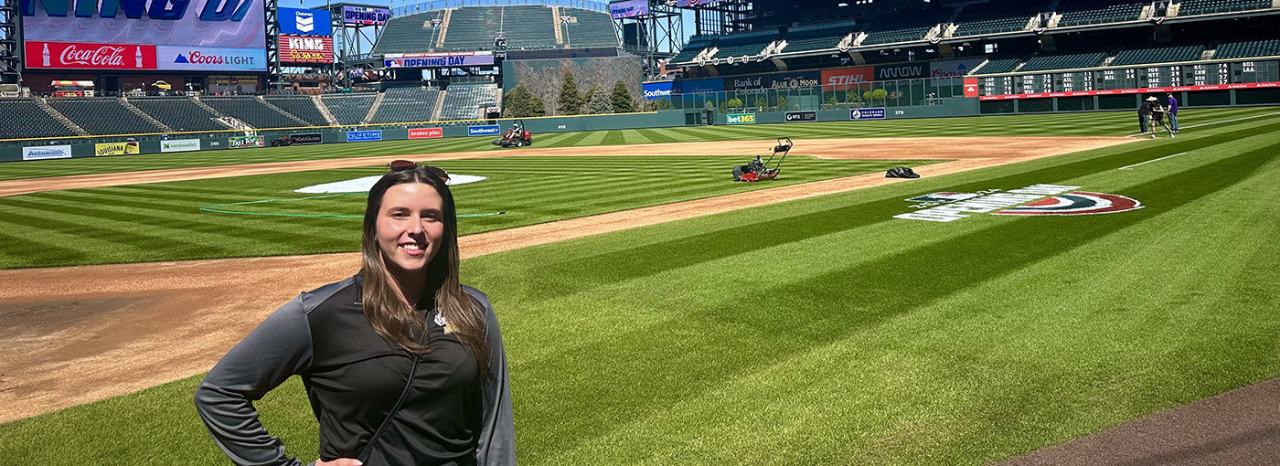 Photo of woman on a baseball field.