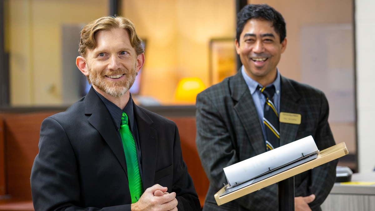 Two Engineering professors presenting at ribbon cutting ceremony.