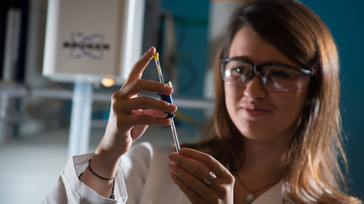 A scientist measuring a sample.